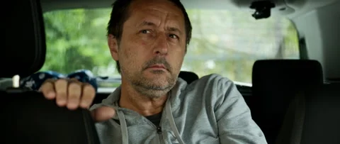 Mature man sitting in the back seat of a car appearing unwell and fatigued... Stock Footage 337022311