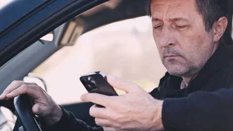 Mature man sitting in car checking smartphone while waiting, everyday commu.. Stock Footage 337532965