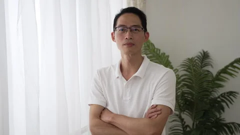 Mature man smiling at camera with folded arms Stock Footage 251432403
