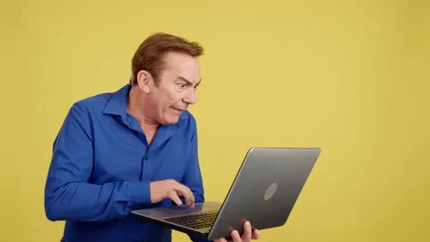 Mature man with a surprised look using a laptop Stock Footage 235655691