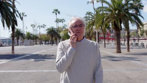 Mature man talking on phone while walking Stock Footage 269504941