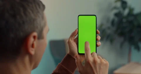 Mature man tapping on green empty screen of smartphone Stock-Footage 167011656