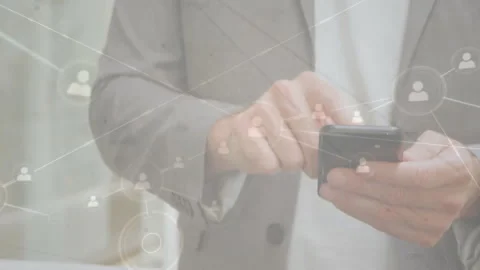 Mature man tapping smartphone in office, expanding profile icons and lines into Stock Footage 309722970