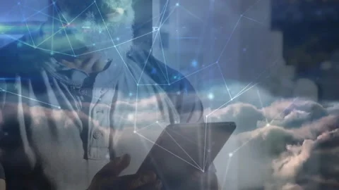 Mature man tapping tablet exploring data with cloud computing overlay and Stock Footage 330400523