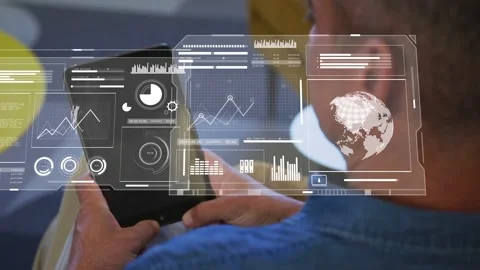 Mature man tapping tablet in lounge and creating HUD charts rearranging for Stock Footage 333336469