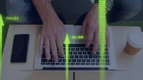 Mature man typing on laptop at table, neon green arrows rising over hands Stock Footage 334703485