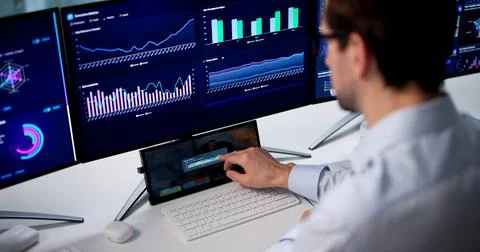Mature Man Uses Computer To Analyze Financial Data And Make Decisions. Stock Photos