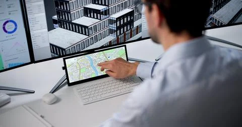 Mature Man Uses Computer Software To Design Urban Map For Construction Projec Stock Photos
