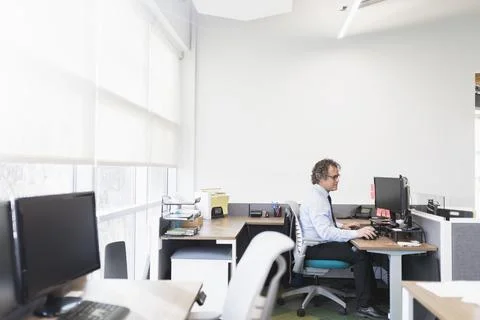 Mature man using computer in office Stock Photos