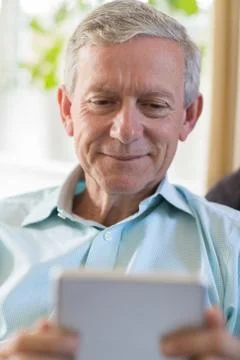 Mature Man Using Digital Tablet At Home 스톡 사진