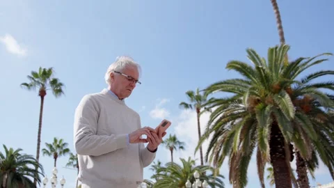 Mature man using gps navigation on phone Stock Footage 270004763