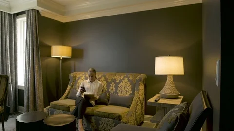 Mature man using a laptop and a mature woman using a cell phone Stock-Footage 77079580