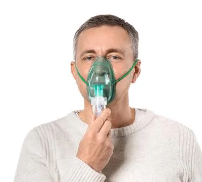 Mature man using nebulizer on white background Stock Photos