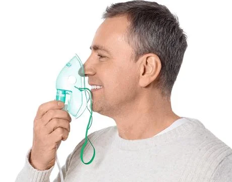 Mature man using nebulizer on white background, closeup Stock Photos