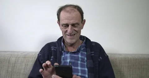 Mature man using smartphone Stock Footage 84328848