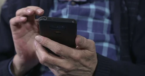 Mature man using a smartphone Stock Footage 84330730