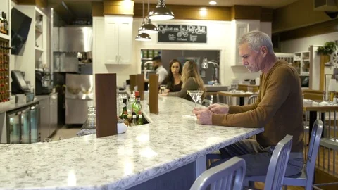 Mature man using a tablet in a bar 動画素材 75209602