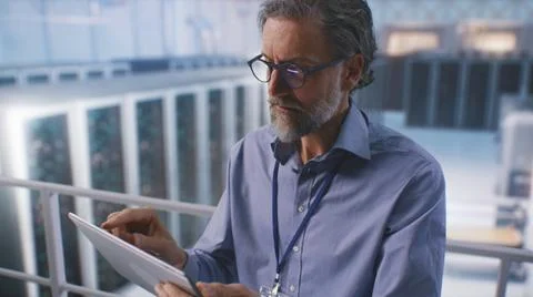 Mature man using tablet in data center Stock Photos