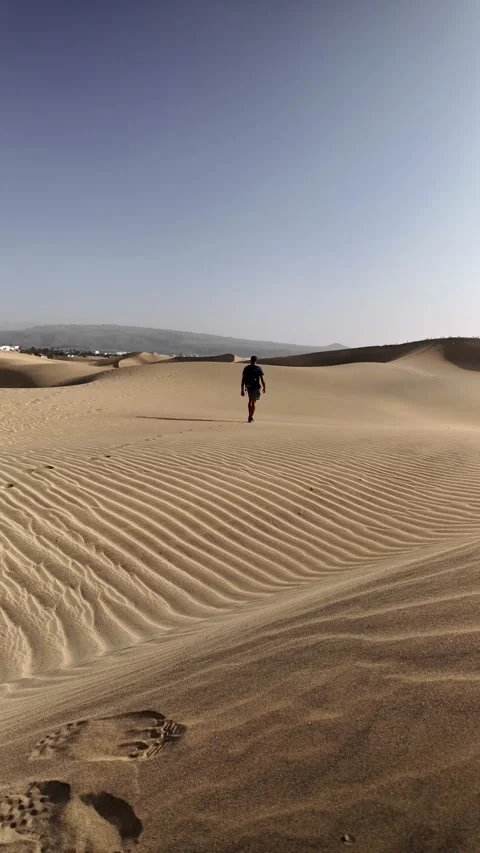 Mature man walking alone in a desert during morning exercise Stock Footage 345093221