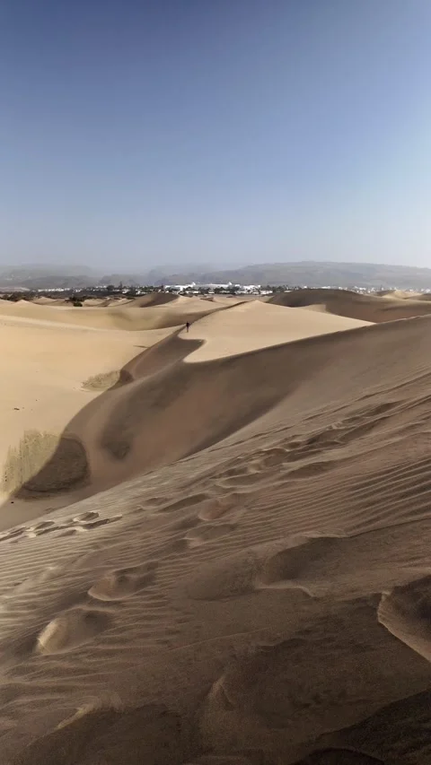 Mature man walking alone on a sand dune in the desert Stock Footage 345093207