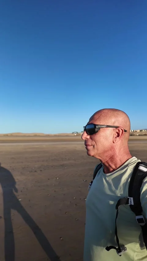 Mature man walking on the beach in slow motion Stock Footage 345839079