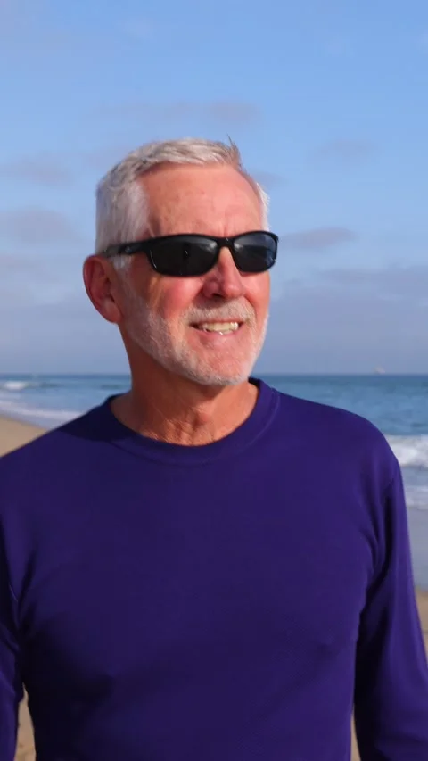 Mature Man Walking At The Beach. Vertical Video. 動画素材 302329068