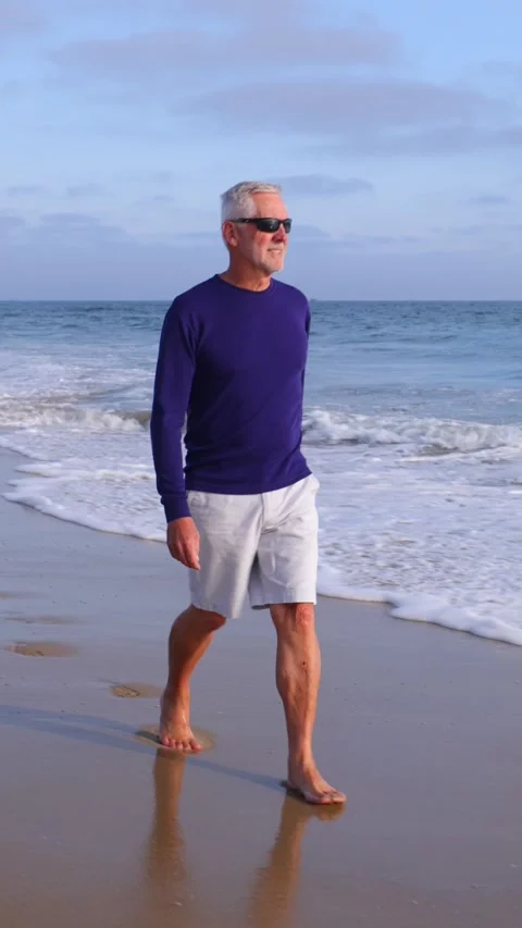Mature Man Walking At The Beach. Vertical Video. 動画素材 302329084