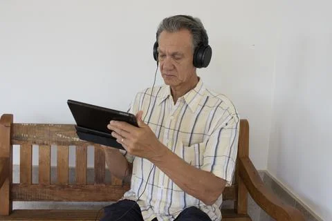 Mature Man watching a show on his iPad Smart Tablet Stock Photos