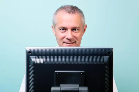 Mature man working at a computer Stock Photos