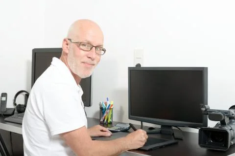 Mature man working with his computer Stock Photos