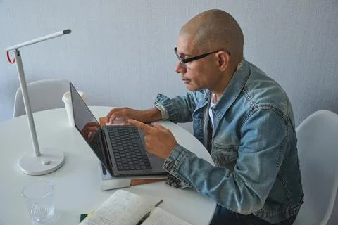 Mature man working from home using laptop 写真素材