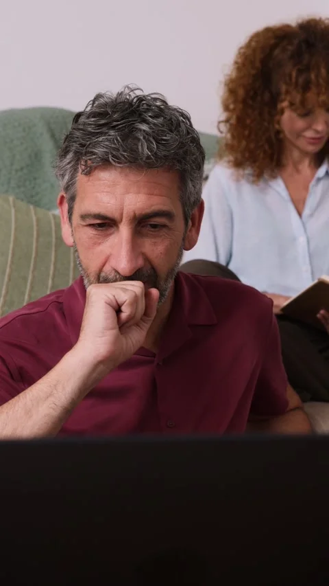 Mature man working on laptop computer at home Stock Footage 343398444