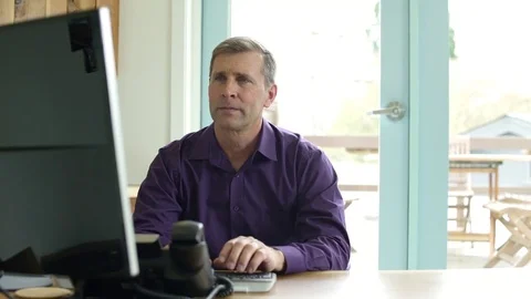 Mature man working in an office Stock Footage 83393833