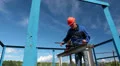 Mature manual worker shut off oil valve gate on big diameter pipeline HD Footage