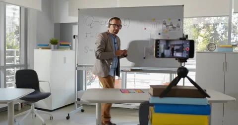 Mature math teacher recording tutorial video for students on smartphone Stock-Footage 243644551