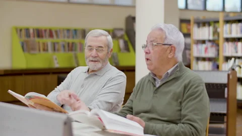 Mature men talking while having lesson in library Stock-Footage 232621013