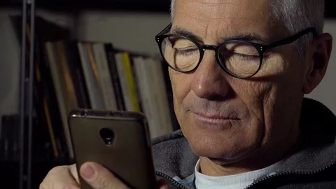 Mature middle aged man using smartphone to send messages: social network, sms Stock Footage 74430752