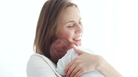 Mature mother holds her sleeping newborn baby in her arms. Surrogacy. IVF. Test Stock Footage