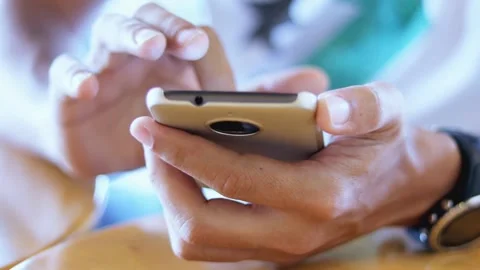 Mature older middle aged old adult holding cellphone scrolling and texting Video stock 336248955
