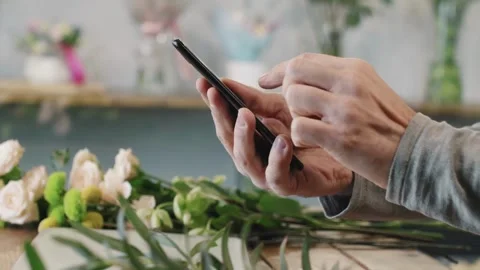 Mature older middle aged old adult holding cellphone scrolling and texting Stock Footage 336249666
