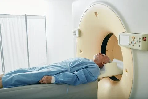 Mature patient going into CT scanner during computed tomography in hospital.. Stock-Fotos
