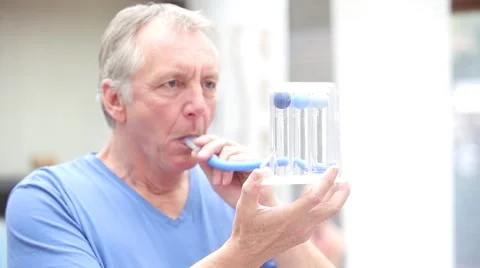 Mature patient making lung function test by using triflow. Stock Footage