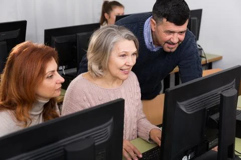 Mature people working together on computer Stock Photos