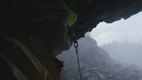 Mature quarry worker looking at a misty mountain landscape Stock Footage 331658733