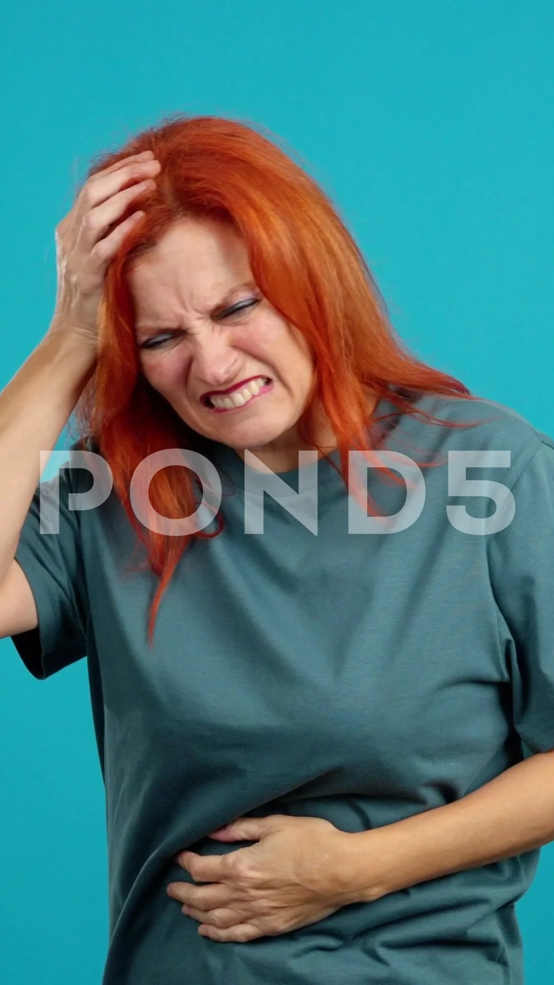 Mature redheaded woman gesturing bodily discomfort and headache