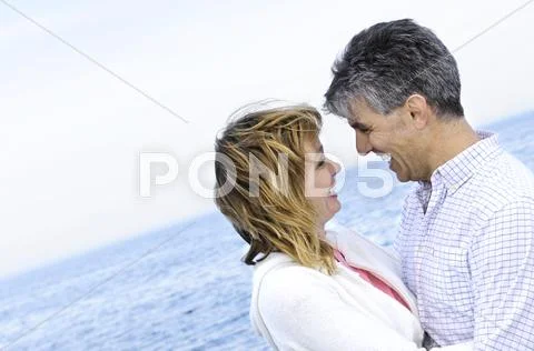 Mature romantic couple at seashore Stock Photos