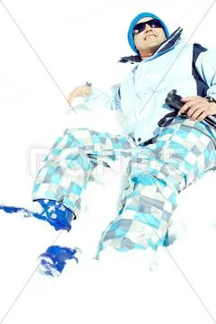 Mature skier lying on snow and smiling Stock Photos