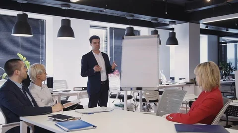 Mature specialists explaining new strategy for colleagues workin Video stock 119411931