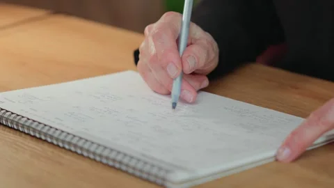 Mature student checking completed tasks in calendar Stock Footage 311672872