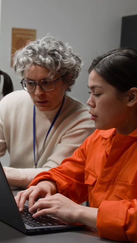 Mature Teacher Assisting Inmate Using Computer Vertical Stock Footage 329011389